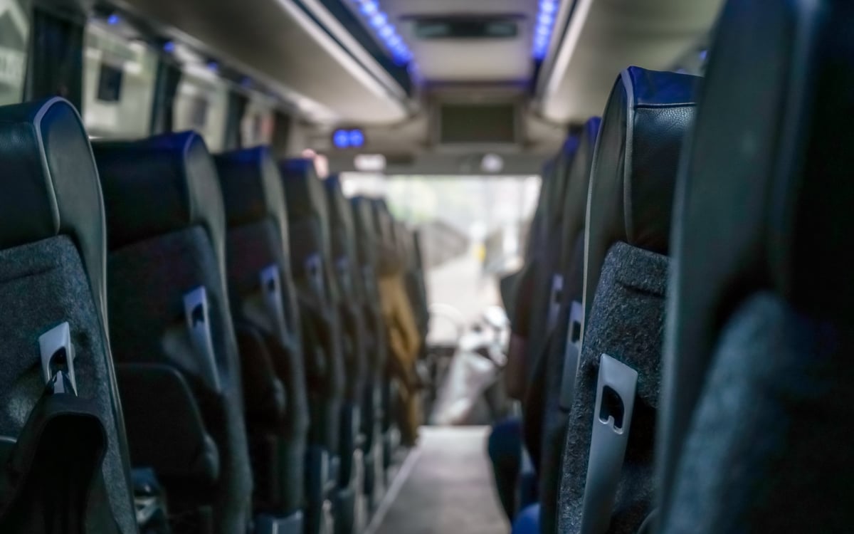 View from the back seat of a coach, passenger seats stretching ahead
