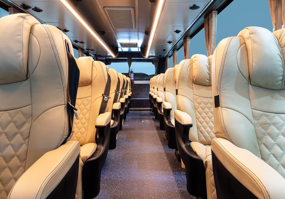 Brown reclining seat rows inside the coach cabin